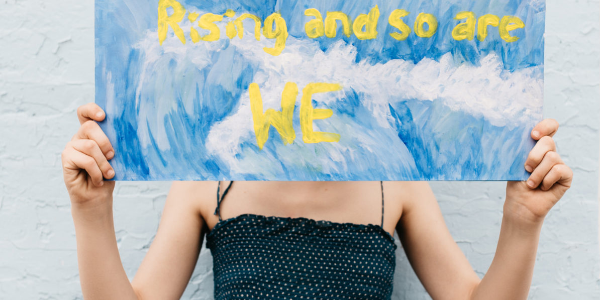 Girl Holds Sign Protesting Climate Change