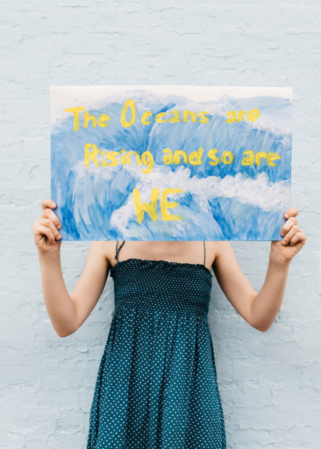 Girl Holds Sign Protesting Climate Change
